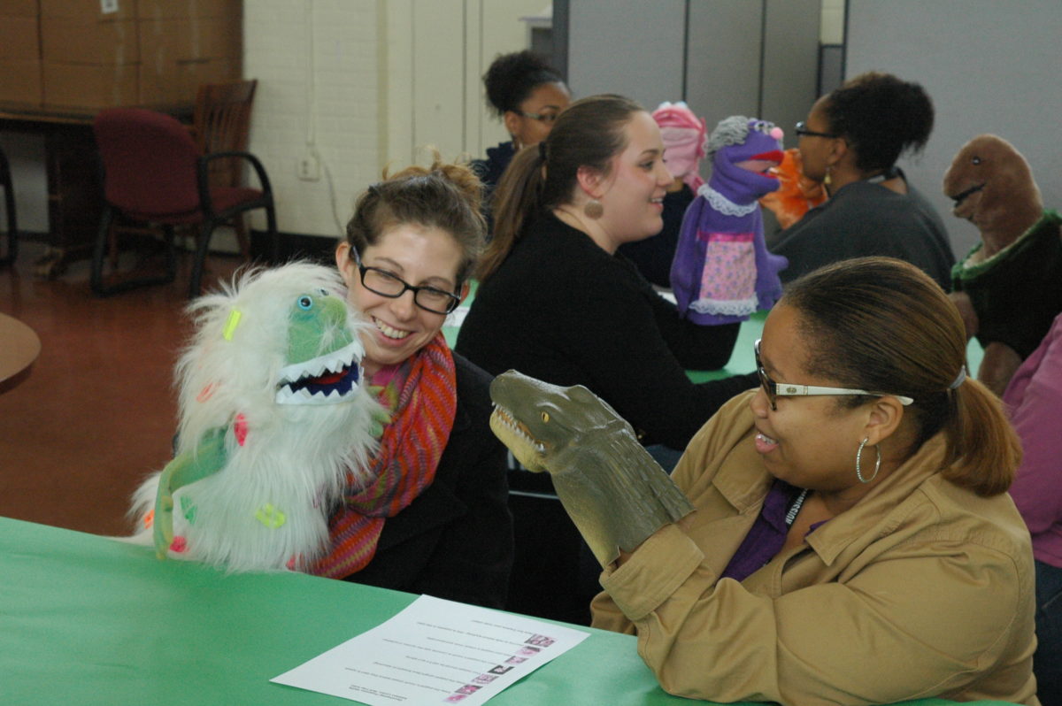 Teachers practicing with puppets